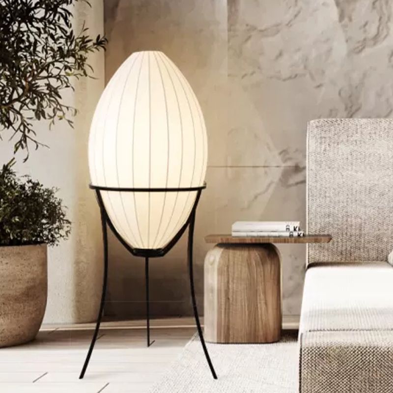 Elegant Japanese geometric floor lamp with a beige shade, perfect for ambient lighting in a living room.