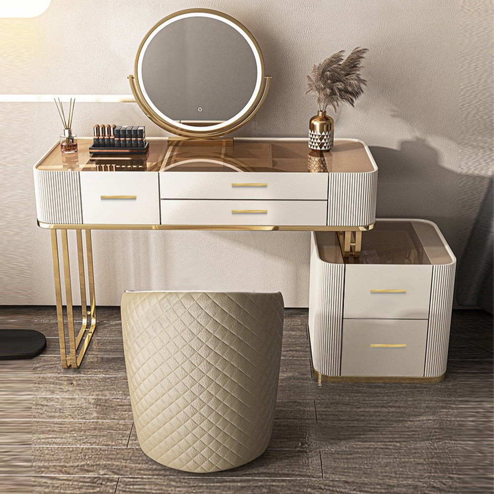 Elegant white gold makeup vanity set featuring a spacious mirror and cushioned stool, perfect for a stylish bedroom.
