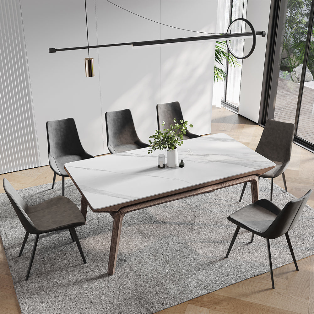 Elegant mid-century modern dining table with a marble top and ash wood legs, set for dinner.