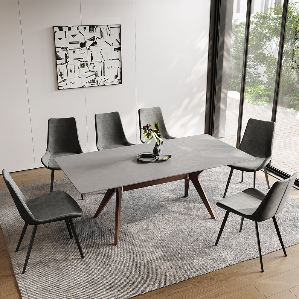 Front view of the modern gray dining table showcasing its sleek design and walnut legs.