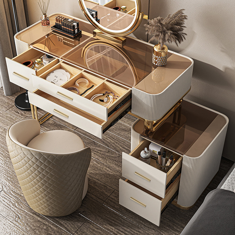 Elegant white gold makeup vanity set featuring a spacious mirror and cushioned stool, perfect for a stylish bedroom.