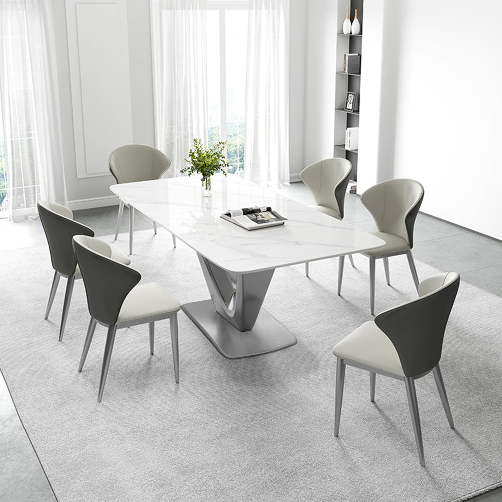 Angled view of marble table with stainless steel V-base in a modern dining room