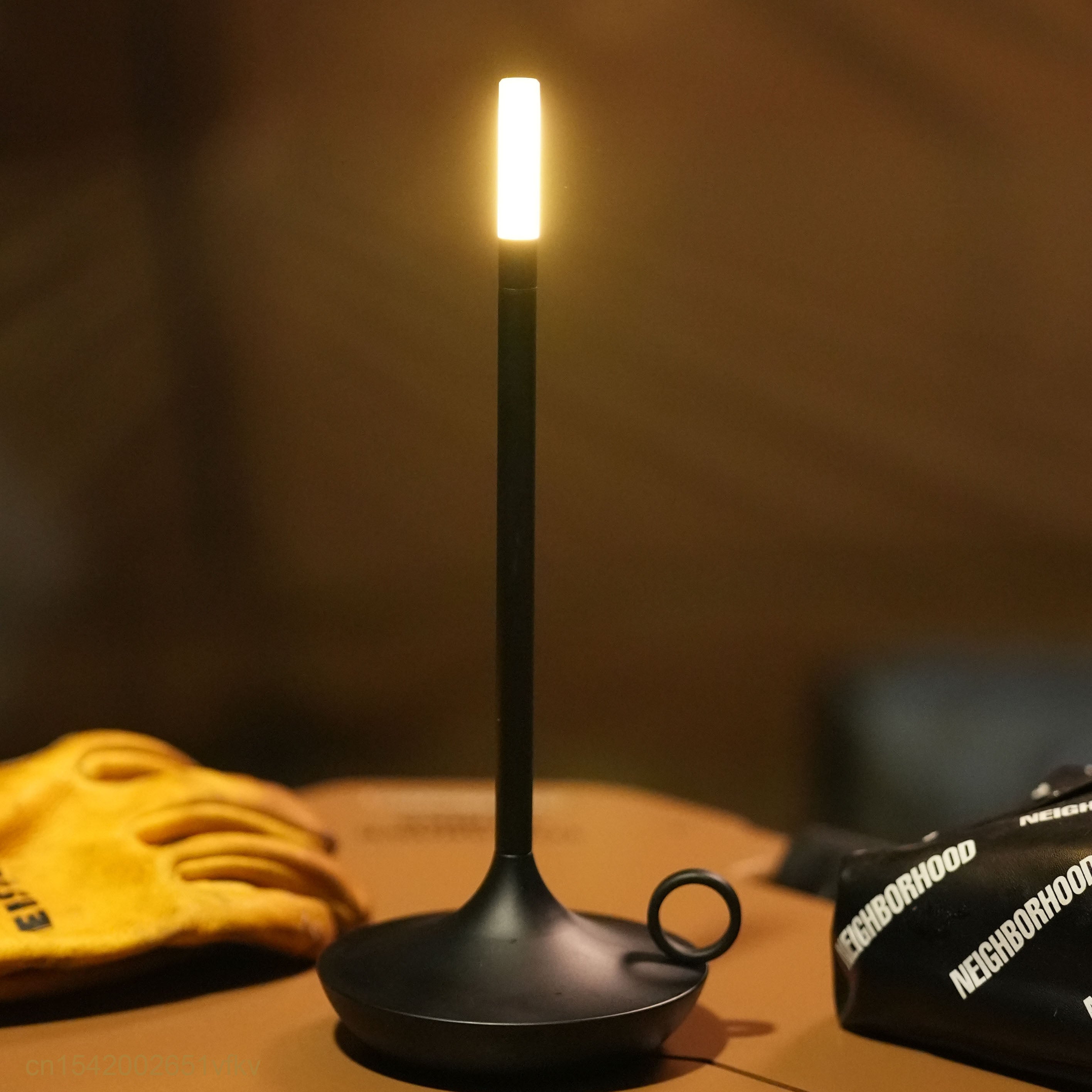 Dimmable candle-style LED table lamp in black, perfect for bedside use.
