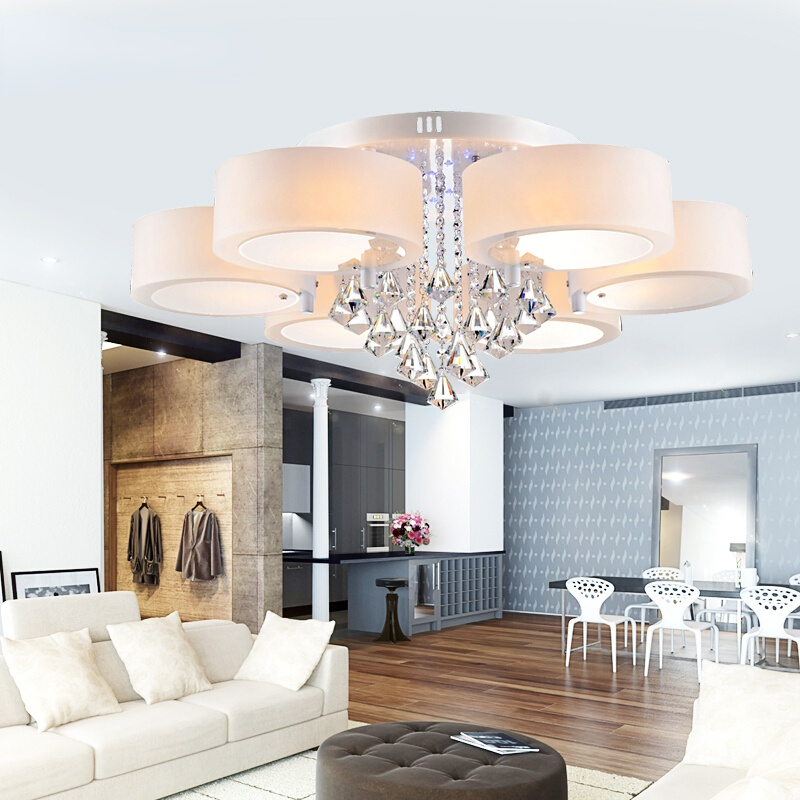 Elegant acrylic raindrop chandelier illuminating a contemporary dining space.