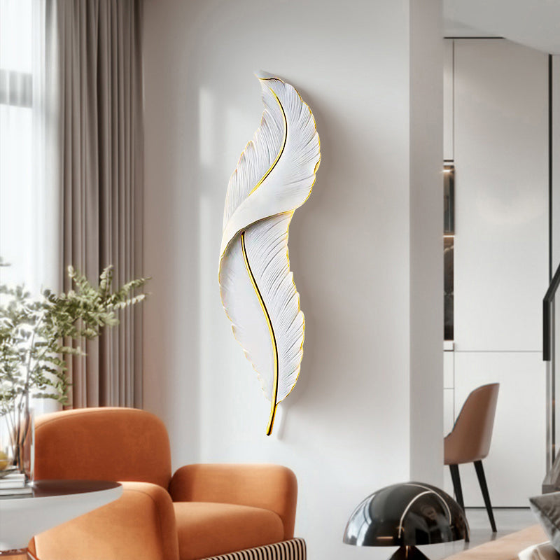 Elegant feather LED wall sconce in a stylish living room setting.
