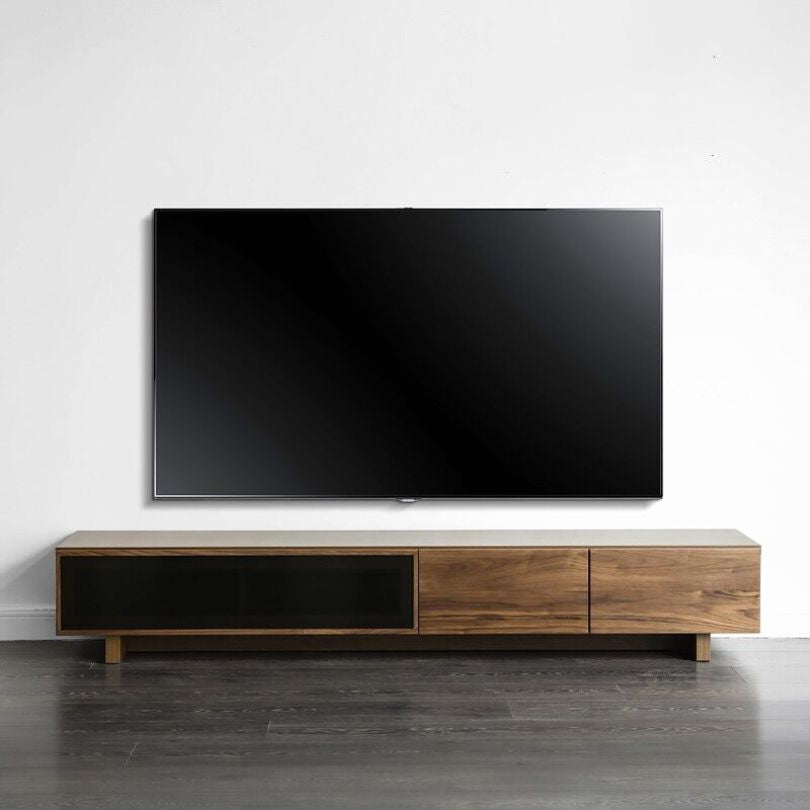 Modern TV console with flip down door showcasing its sleek design and warm walnut finish.