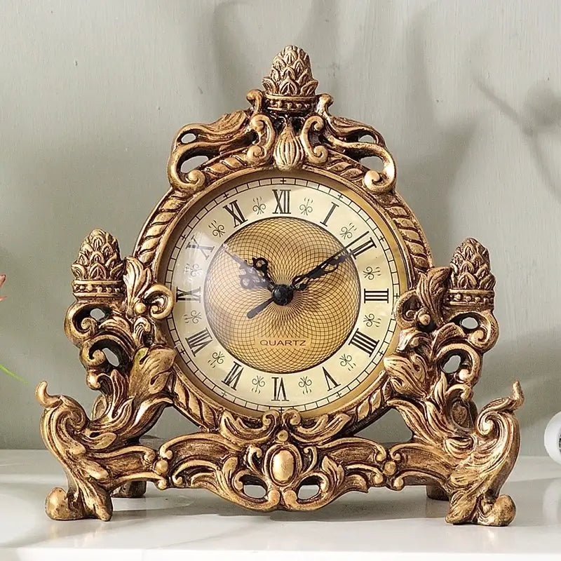 Front-facing view of vintage clock showing detailed crown design and gold-blue finish
