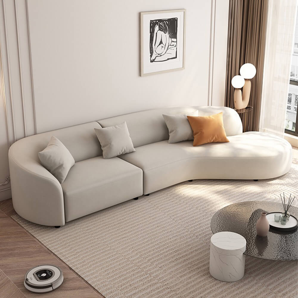 Elegant curved white upholstered sectional sofa viewed from the side, showcasing its modern design and spacious seating.