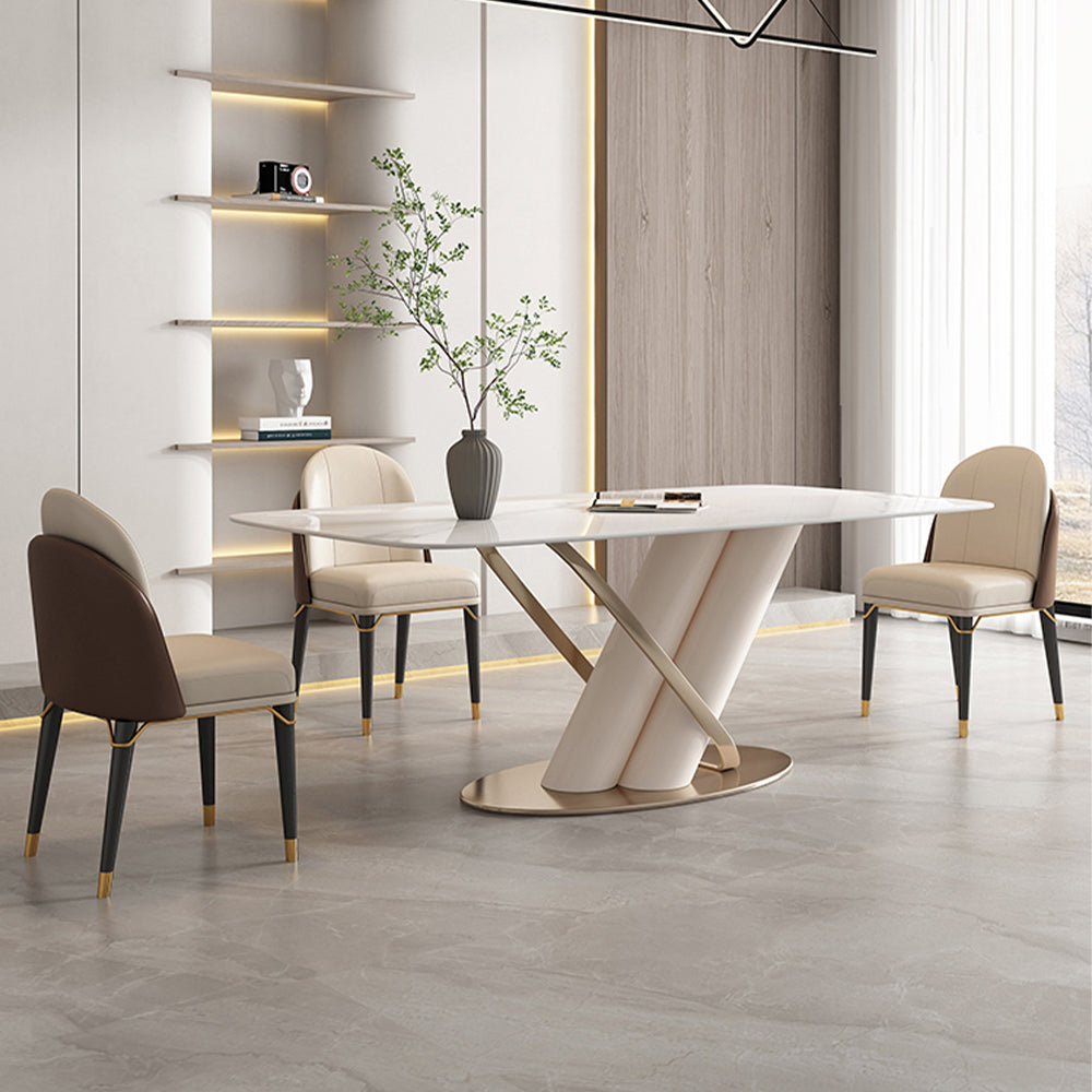 Angled view of modern dining table with X-shaped gold pedestal base