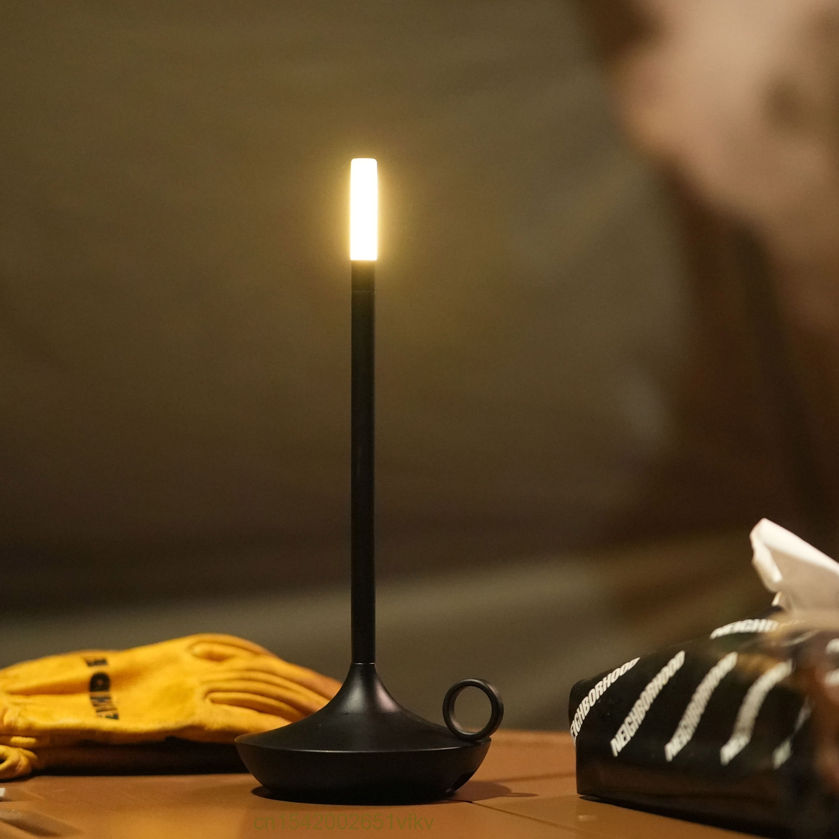 Dimmable candle-style LED table lamp in black, perfect for bedside use.