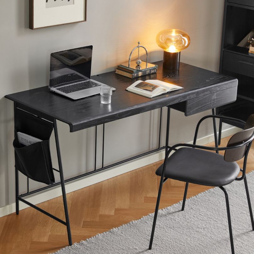 Close-up of the desks rounded edges and silent drawer rails highlighting its modern features.