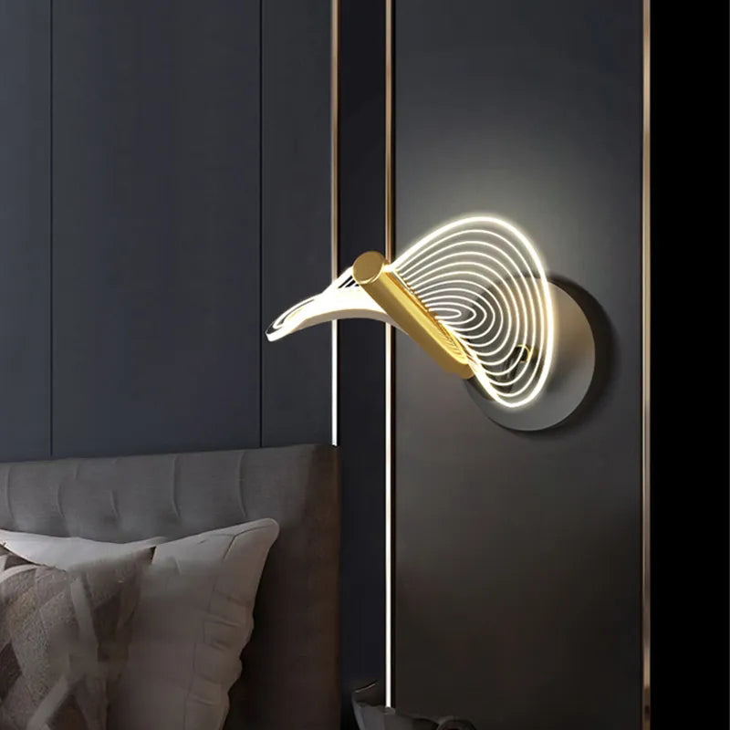Gold wall light installed in a modern dining room, providing ambient lighting.