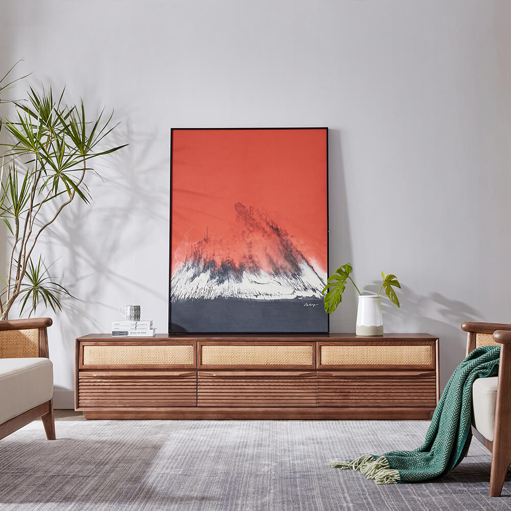Chic mid-century walnut and rattan TV stand from a side angle, showcasing its sleek design and rattan drawers.