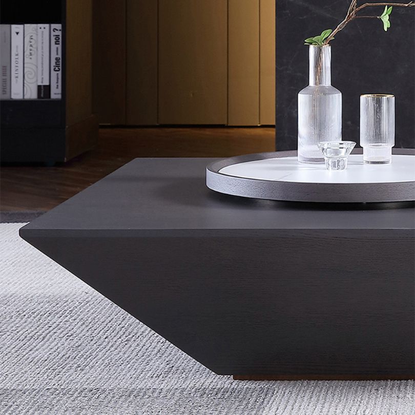 Close-up of the minimalist black coffee table showcasing the round Lazy Susan feature.
