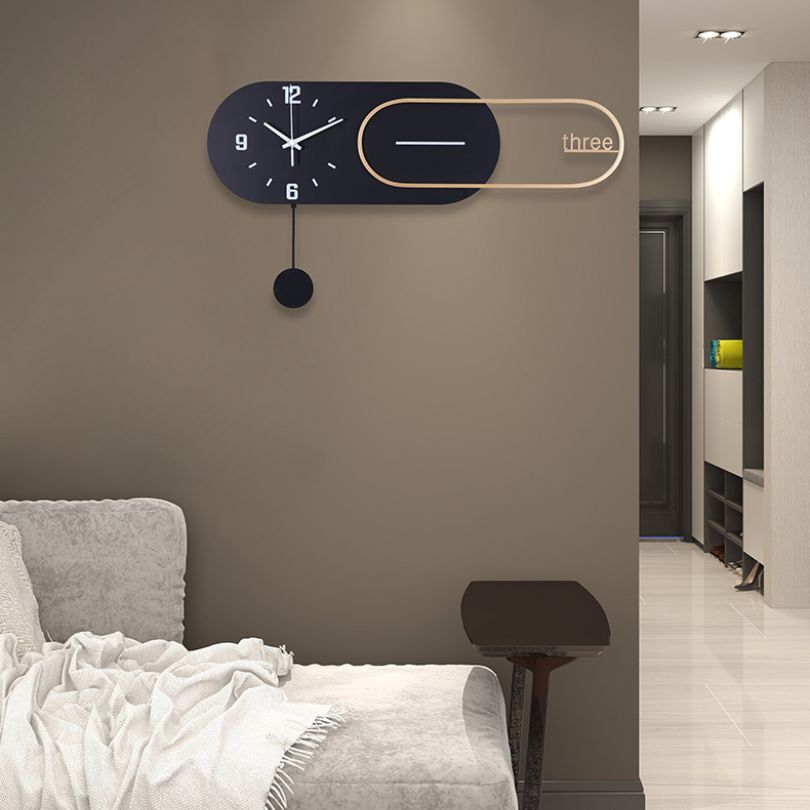 Sleek black wall clock displayed in a modern living room setting, accentuating minimalist decor.