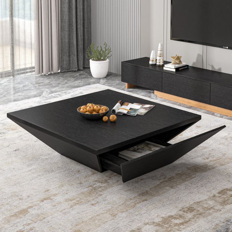 The minimalist walnut coffee table in a cozy living room setting, highlighting its functionality and storage drawer.