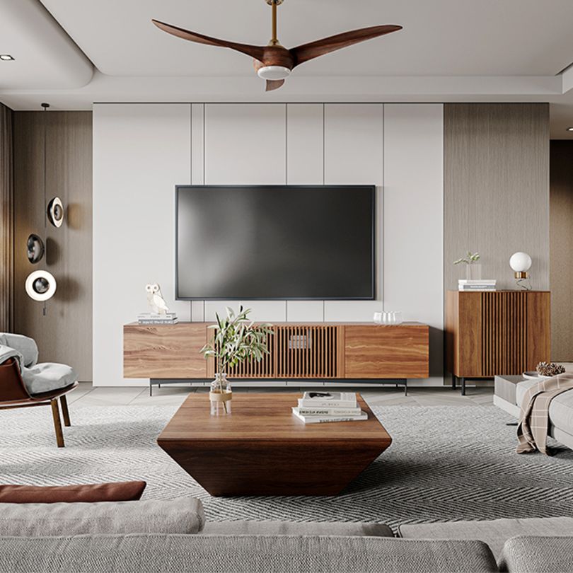 The minimalist walnut coffee table in a cozy living room setting, highlighting its functionality and storage drawer.