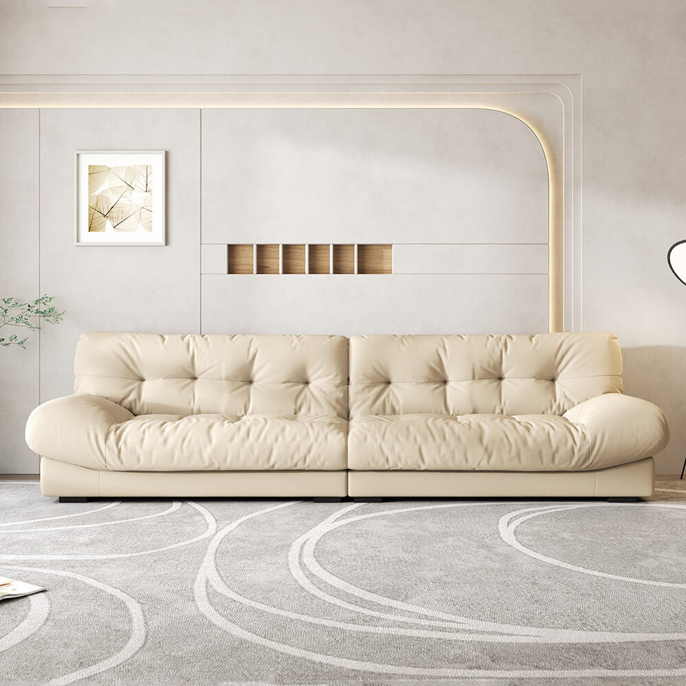 Chic beige velvet sectional sofa with arms, angled view in a cozy living room