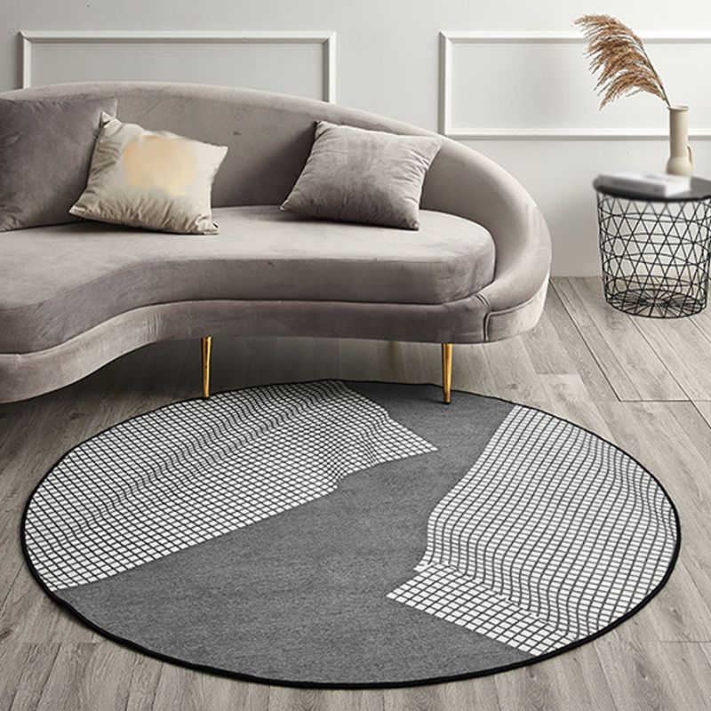 Chic Geometric Chenille Round Grey Area Rug placed in a cozy living room setting, highlighting its modern design and texture.