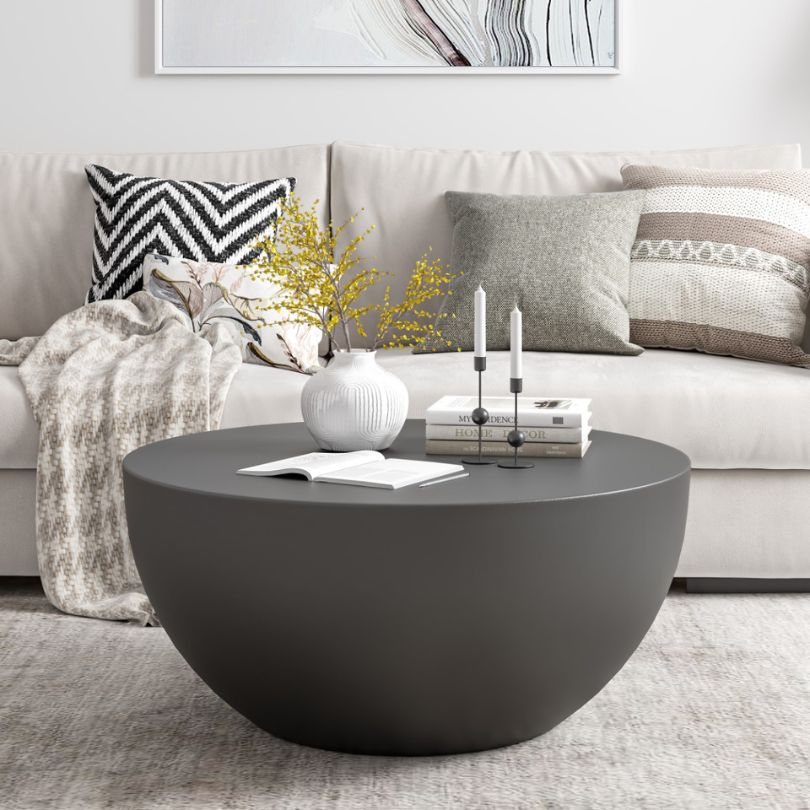 Chic black fiberglass drum coffee table from the side, showcasing its elegant design.