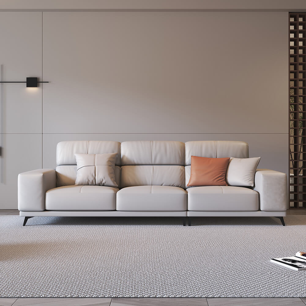 Chic modern leather sectional sofa with metal legs in a cozy living room setting.