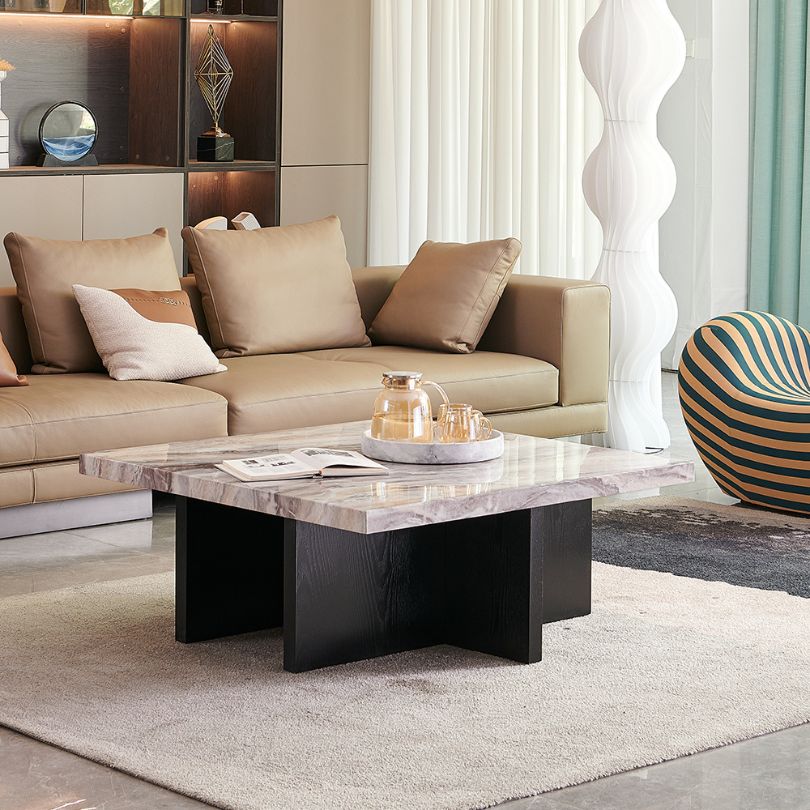 Chic marble coffee table with wooden base in a bright living room setting.