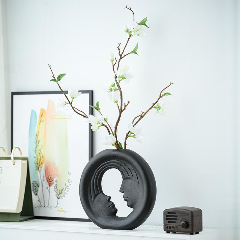 Chic couple aesthetic ceramic vase displayed on a stylish table with flowers.