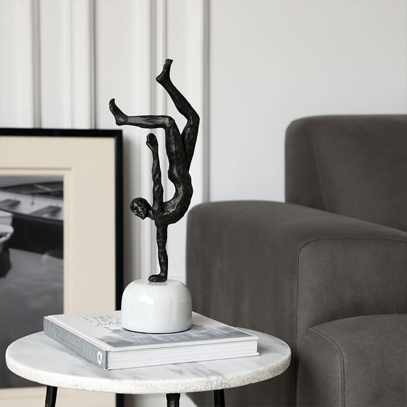 Front view of the Nordic Grace Inverted Figure Cast Iron Sculpture on a marble pedestal.