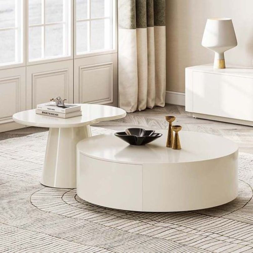 The Nordic Serenity Rounded Coffee Table placed in a cozy living room, highlighting its functionality and aesthetic appeal.