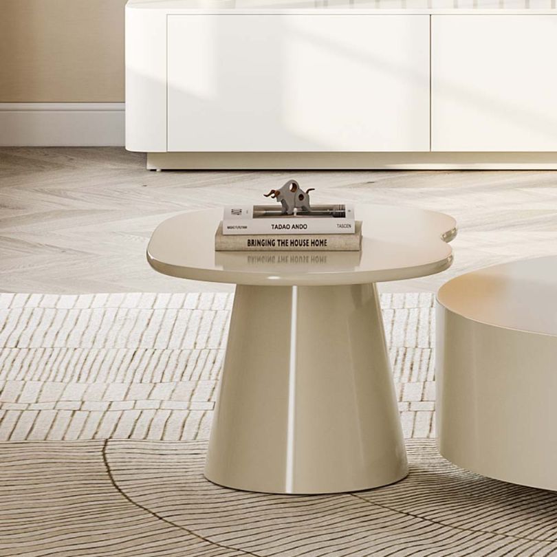The Nordic Serenity Rounded Coffee Table placed in a cozy living room, highlighting its functionality and aesthetic appeal.