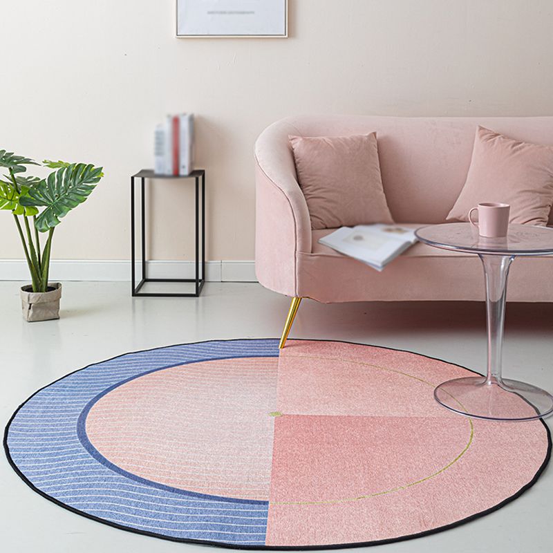 Chic Pink and Blue Striped Area Rug displayed in a modern living room