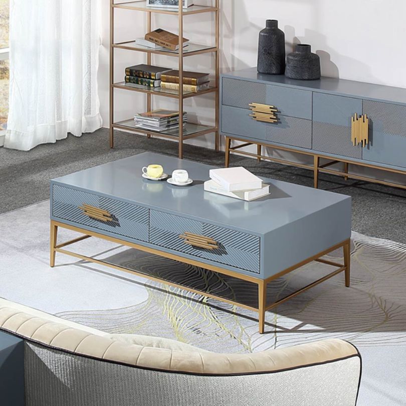 Elegant blue veneer modern coffee table with four drawers, showcasing its vibrant color and sturdy legs.