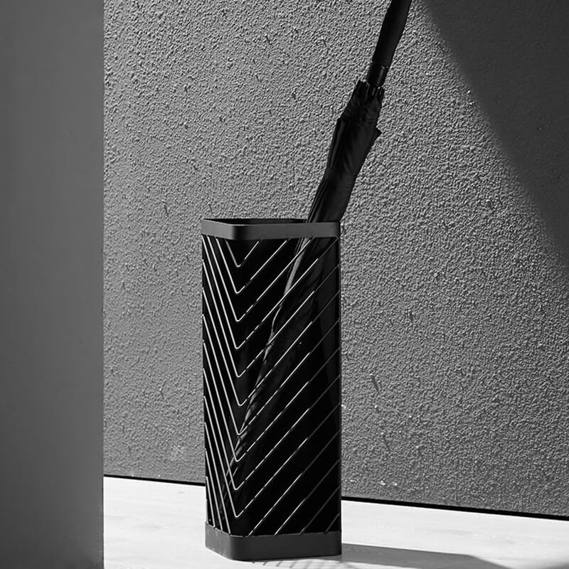 Chic metal umbrella organizer stand in a hallway with umbrellas stored elegantly.