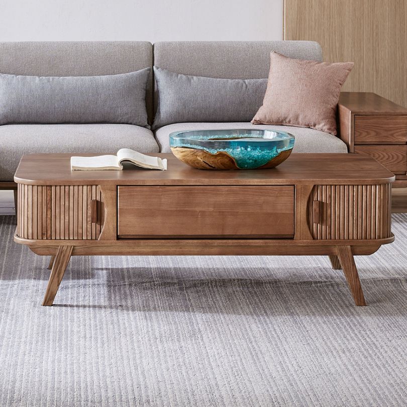 Modern wooden coffee table showcasing sliding rail doors from a side angle.