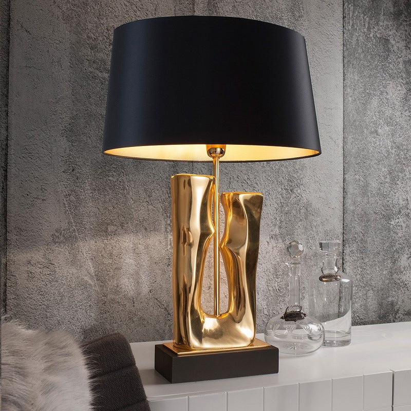 Elegant Nordic Ceramic Table Lamp showcasing its gold body and black shade from the side