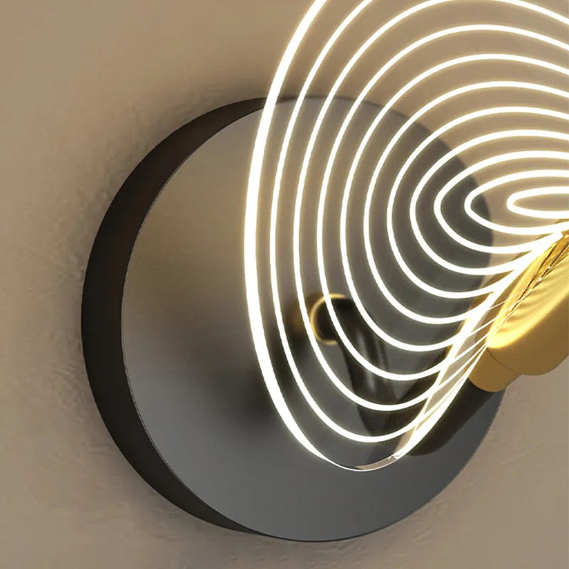 Elegant gold wall sconce in an entryway, enhancing the overall decor with its unique shape.