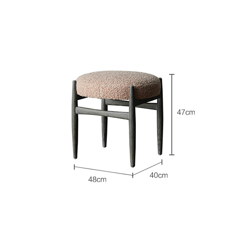 Close-up view of the oak legs and plush velvet seat of the vanity chair.